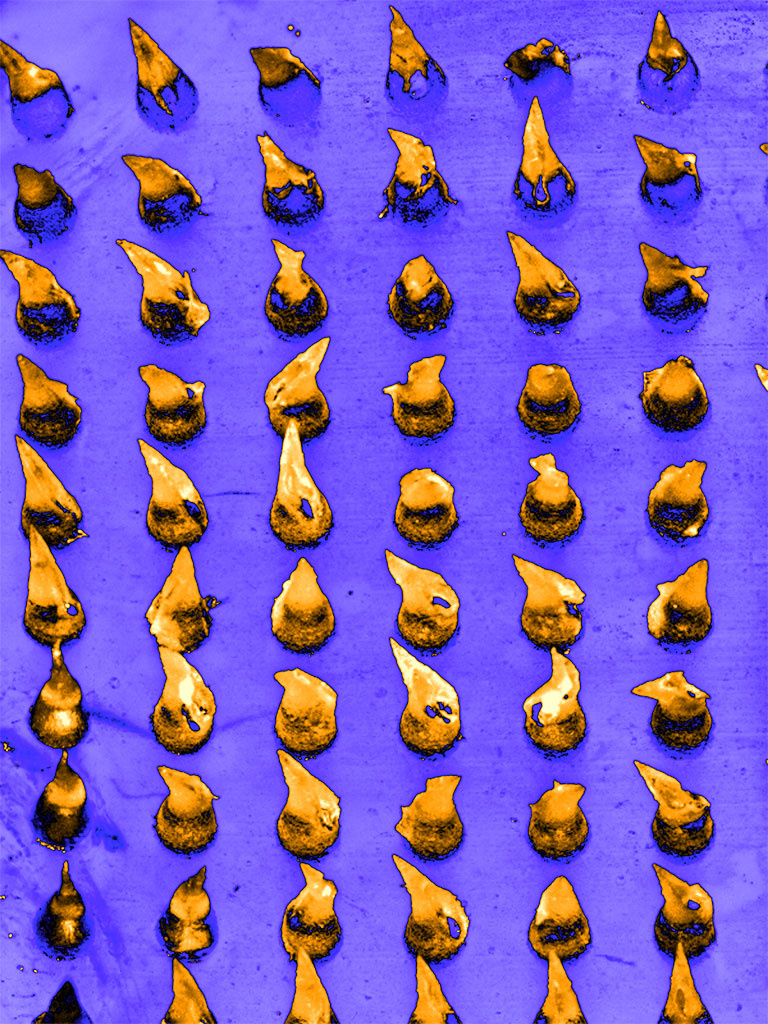 grid of rounded gold cones on an indigo background