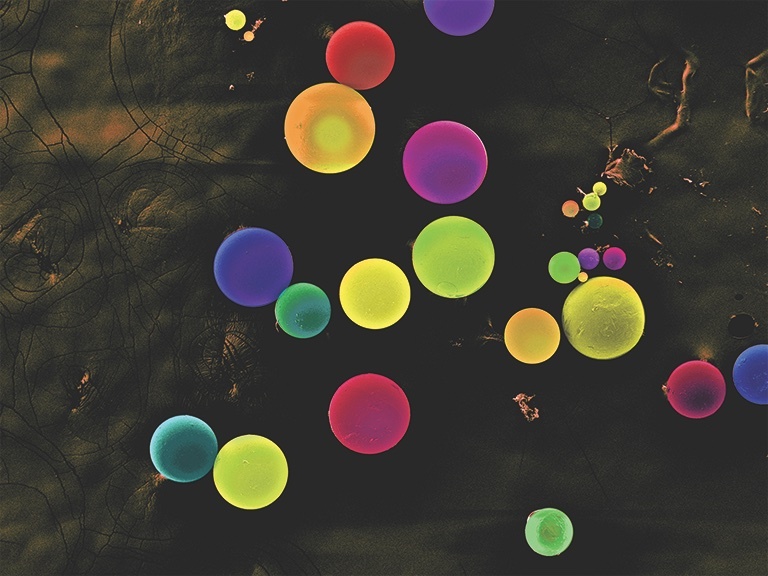 colorful spheres on a mottled black background