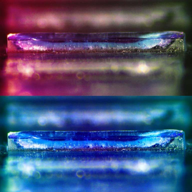 two images of iridescent polymer containers—pinkish on the top and bluish on the bottom.