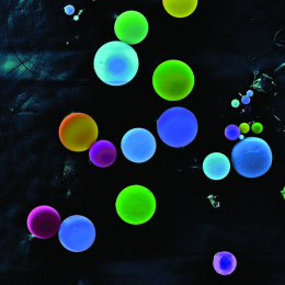 fluorescently colored spheres in pale shades of blue and green