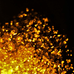 cells (in gold) disperse upward against a black background