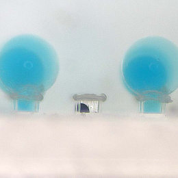 blue bubbles emerging from clear rectangular capsules
