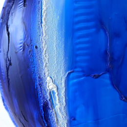 glossy curves in varying shades of blue form a convex surface with ridges, cracks, and striations